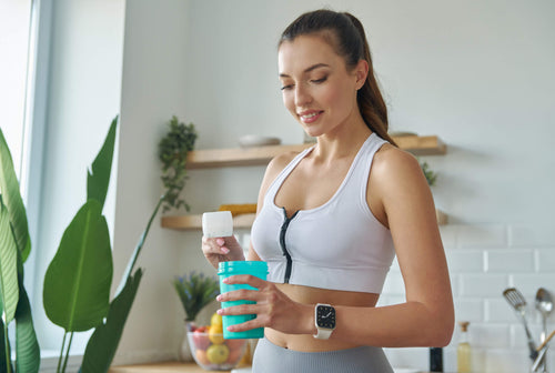 woman scooping out creatine powder